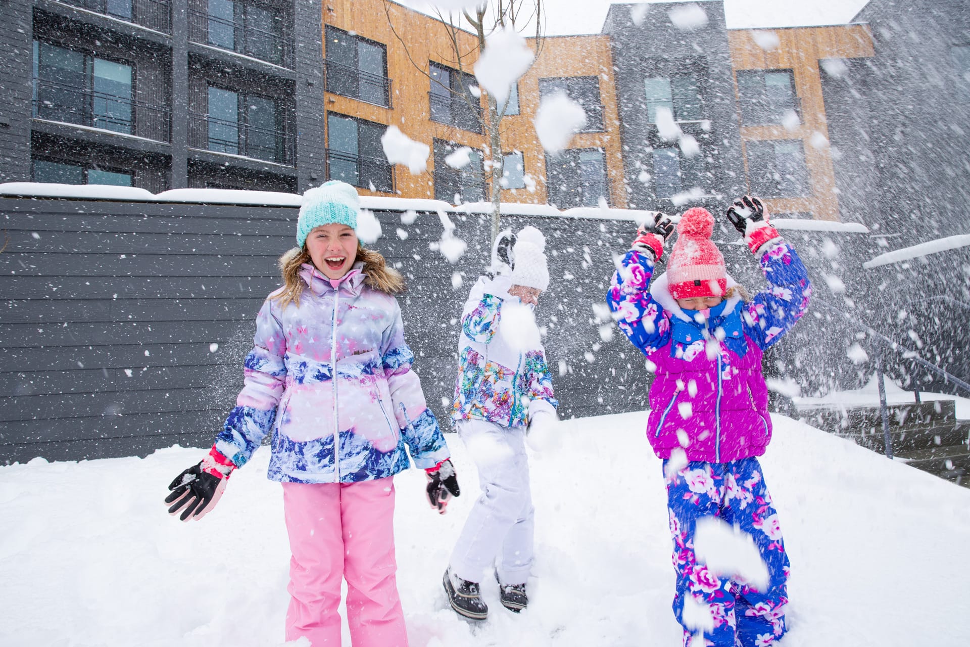 Kids enjoying fresh snow outside Canyon Haus