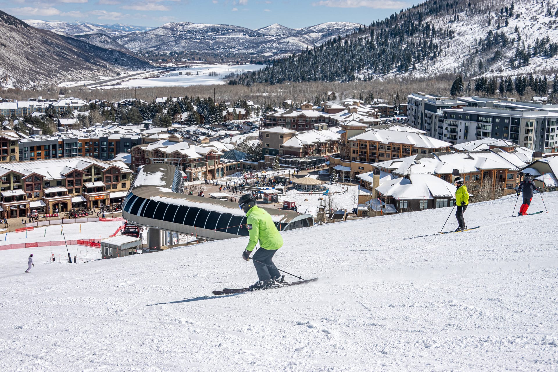 Skiers on a sunny spring day at Canyons Village in Park City